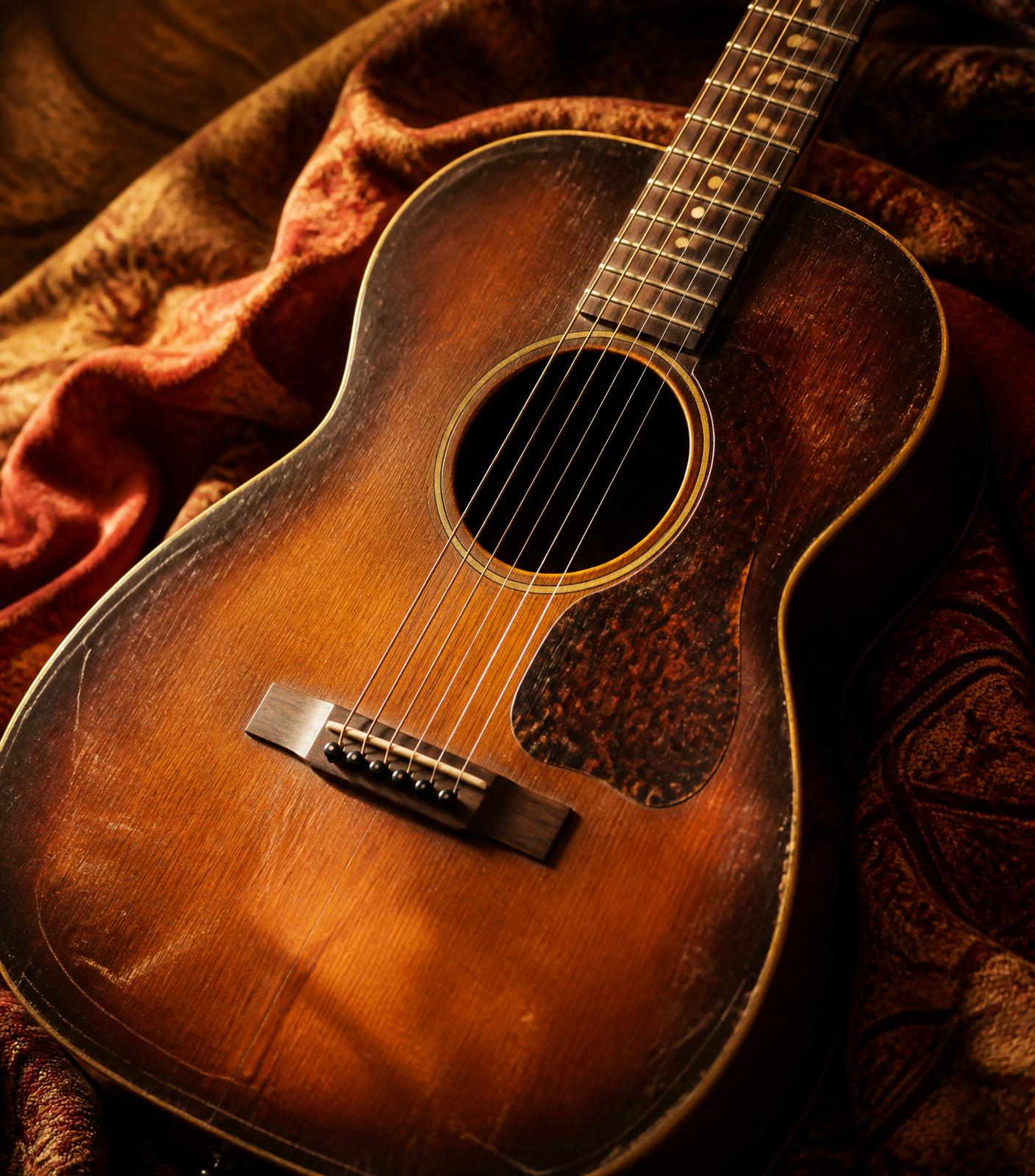A warm vintage acoustic guitar bathed in low light